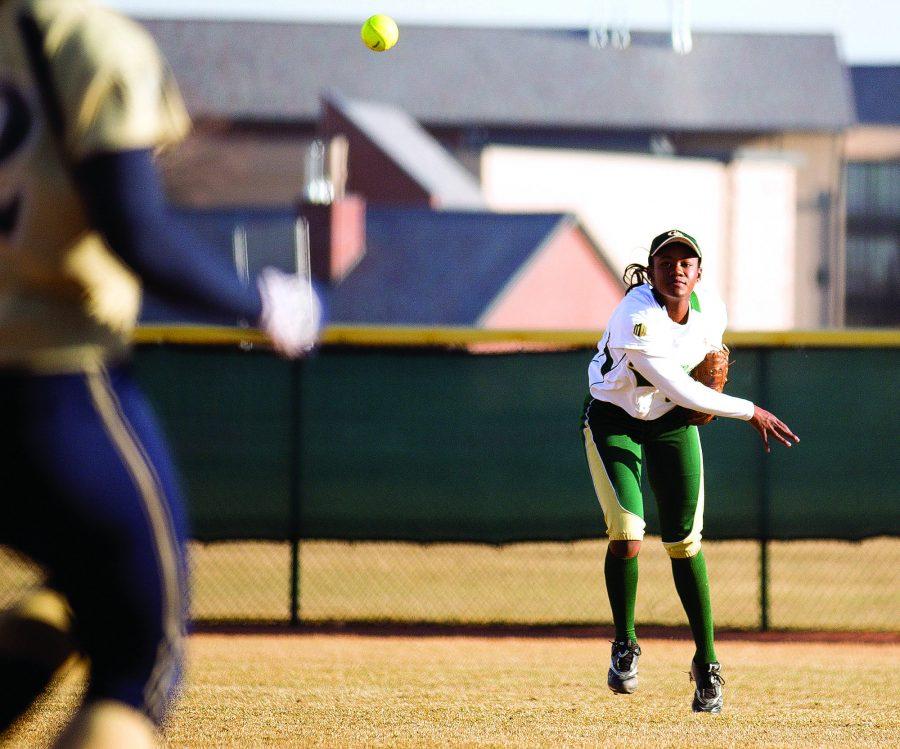 Sophomore Molly Randle, right, throws to first base after a pop fly that ended in a single at the softball game against Northern Colorado. The Rams won 10-0.