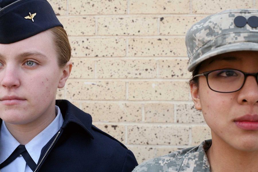 Air Force ROTC member Holly Frock, left, stands at attention with Army ROTC member Rebecca Gogue, right, outside of the Military Sciences Building.