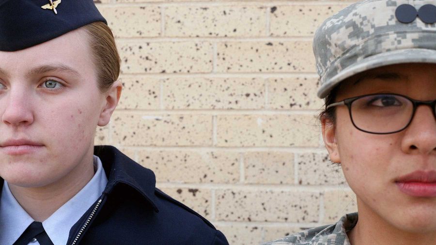 Air Force ROTC member Holly Frock, left, stands at attention with Army ROTC member Rebecca Gogue, right, outside of the Military Sciences Building.