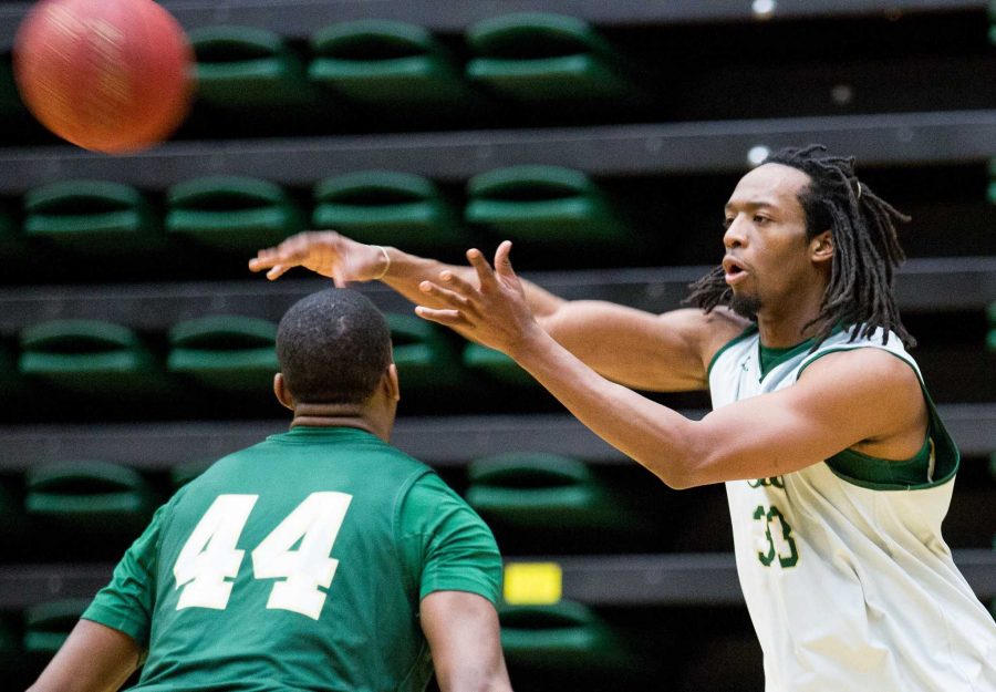 Dwight Smith, 33, passes the ball over his brother Greg Smith's shoulder in practice Monday morning in Moby Arena. After having a good season last year, Dwight chose to red shirt this season.
