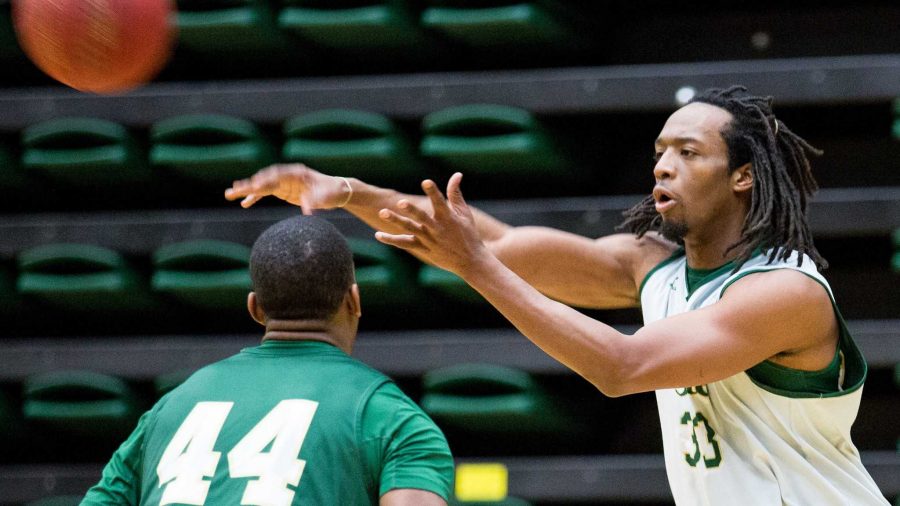 Dwight Smith, 33, passes the ball over his brother Greg Smith's shoulder in practice Monday morning in Moby Arena. After having a good season last year, Dwight chose to red shirt this season.