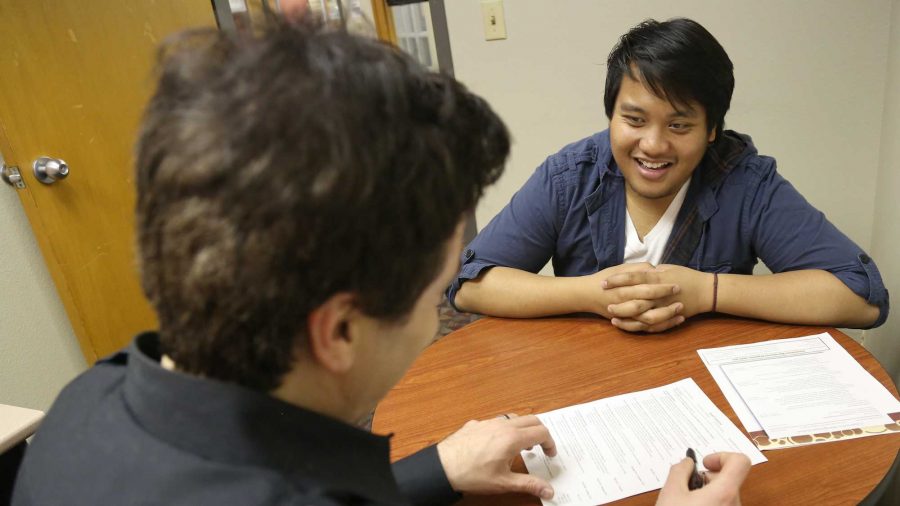Senior political science major Josef Canaria recieves resume advice from career counsler Jon Linn in the Career Center Wednesday afternoon. With graduation coming soon, many students are going the extra mile to impress prospective employers.