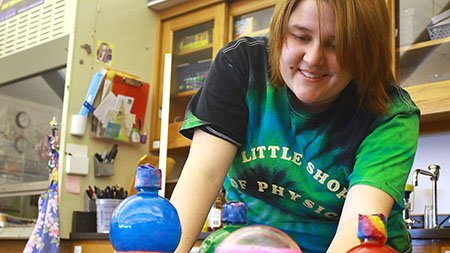 Anthropology major Haeli Leighty tests one of the many mind boggling scientific displays in the Little Shop of Physics lab. The Native American Cultural Center is teaming up with the Little Shop of Physics to give the communitys youth a chance to learn about College.