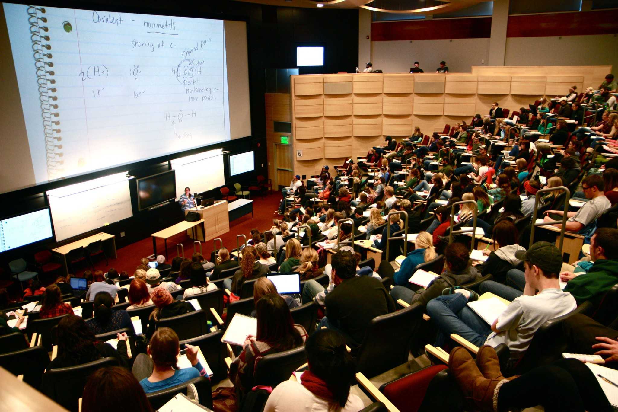 A 400 seat lecture room in Behavioral Sciences Building is packed full with mostly Freshman students enrolled in Chemistry 107.