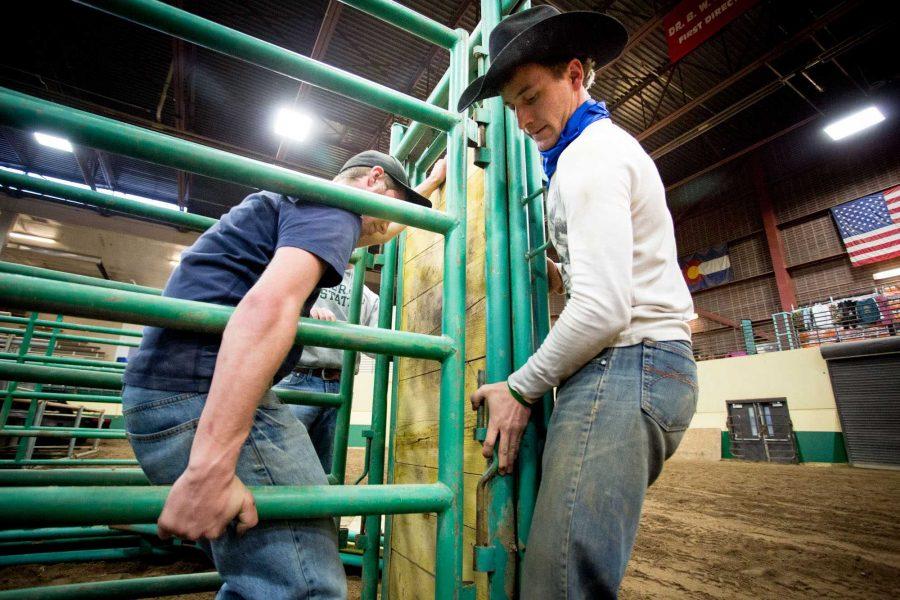 Agriculture business majors Travis Jackson, left, and Shiloh Wittler set up barriers for the Skyline Stampede Rodeo at the BW Pickett Equine Center Wednesday evening.