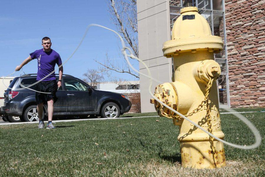 Sophmore international studies major Kyle Hartshorn practices his roping techniqe on a fire hydrant outside of Edwards Hall Sunday afternoon. With the recent nice weather spring is clearly in the air and students are begin to once again take many activities outdoors.