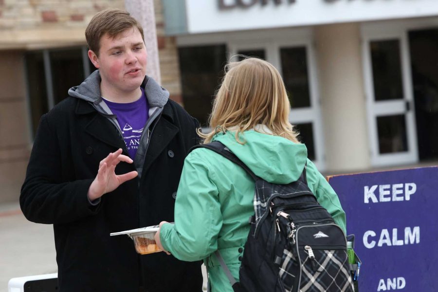 ASCSU vice presidential candidate Andrew Olson, left, explains his running platform to senior spanish education major Stacit Stubbendick outside of the Lory Student Center Tuesday afternoon. The ASCSU presidential debate will take place tonight in the LSC Theater.