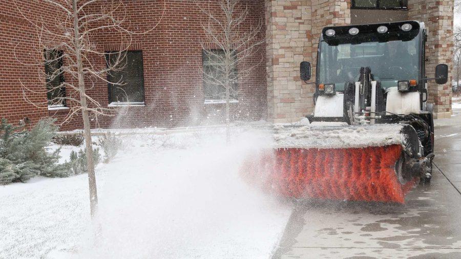 Grounds maintinence supervisor Rodney Gillespie uses a snow broom to clear snow in front of the Acedemic Village Tuesday afternoon. Various groups on campus, including CSU's ROTC program, shovel snow at the crack of dawn to clear the way for the tens of thousands who work and study at the university.
