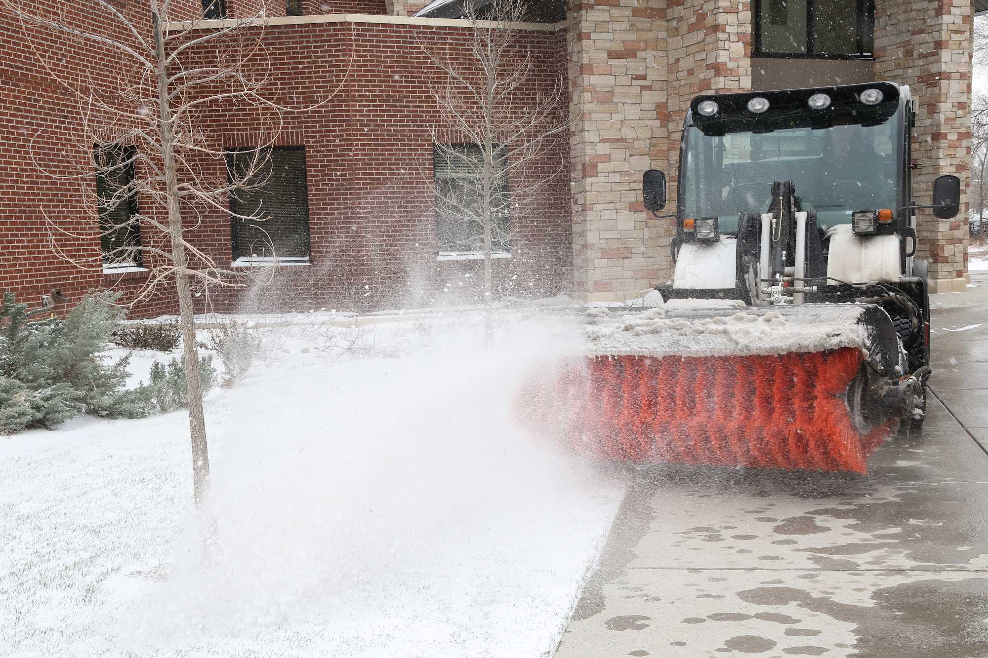 Grounds maintinence supervisor Rodney Gillespie uses a snow broom to clear snow in front of the Acedemic Village Tuesday afternoon. Various groups on campus, including CSU's ROTC program, shovel snow at the crack of dawn to clear the way for the tens of thousands who work and study at the university.