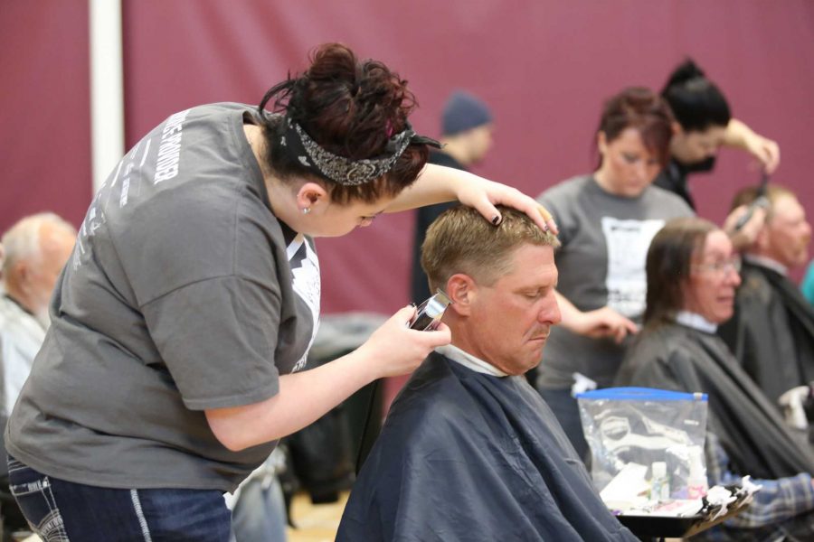 Fort Collins homeless resident And Swanson recieves a free haircut from volunteer Teri Luna of Cheeks Beauty School during Project Homeless Connect at the Atzlan Community Center Friday morning. The annual event provides individuals and families suffering with homelessness with neccesary ammenities including doctor checkups, dental help, veterinary services and haircuts.