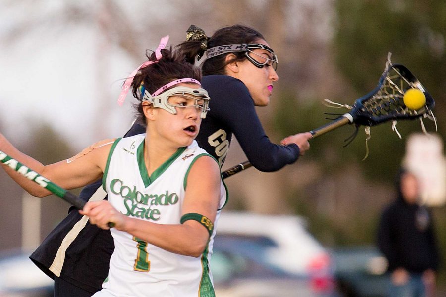 Colorado State senior Attacker Maddie Garcia, 1, fights for the ball against a Colorado defender in the matchup on the intramural fields Thursday night.
