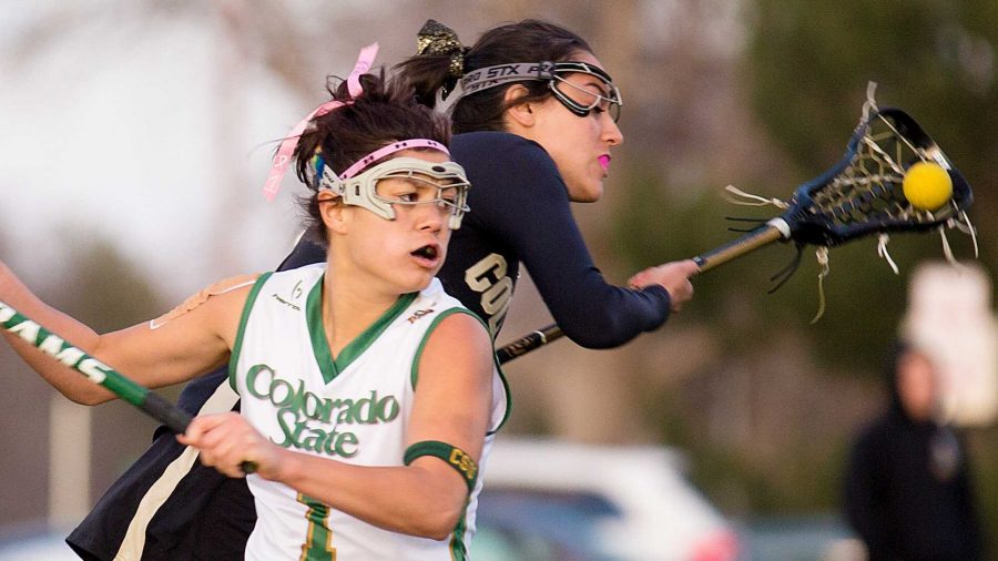 Colorado State senior Attacker Maddie Garcia, 1, fights for the ball against a Colorado defender in the matchup on the intramural fields Thursday night.