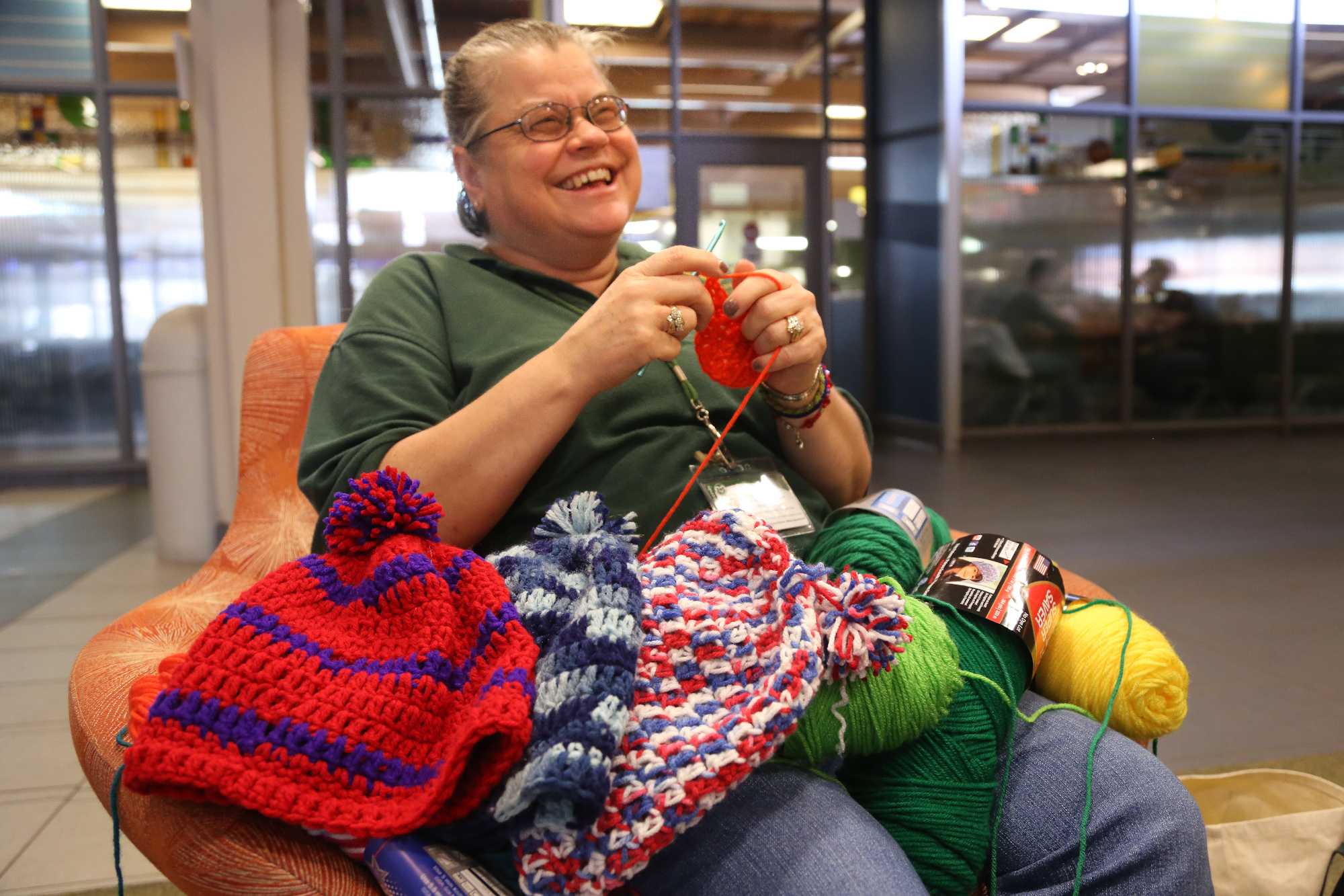 Braiden Hall Environmental Technician Ellen Becker crochets a hat in Braiden last week. Becker, who began crocheting for students 7 years ago, now makes hats for every resident in Braiden as well as Tony Frank and other prominent figures on campus.