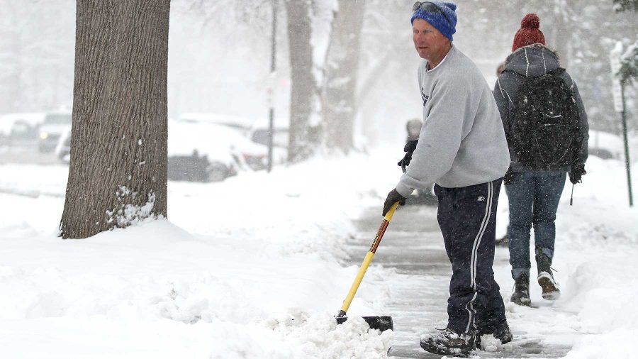 Dave Dean shovels snows off his sidewalk on Meldrum on Monday afternoon.
