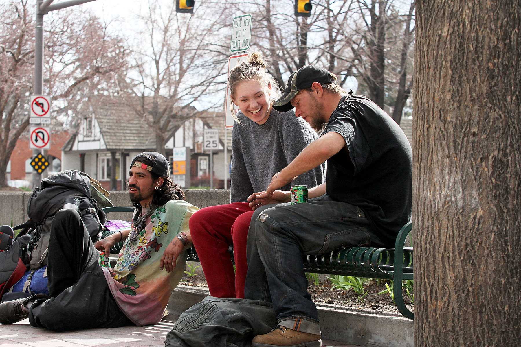 Collegian reporter, Cailley Biagini, talks to two "hobo travelers" named Fishtaco (left) and Beer (right) in Old Town on Friday afternoon. Biagini went undercover for an afternoon to find out how Fort Collins homeless people are treated.