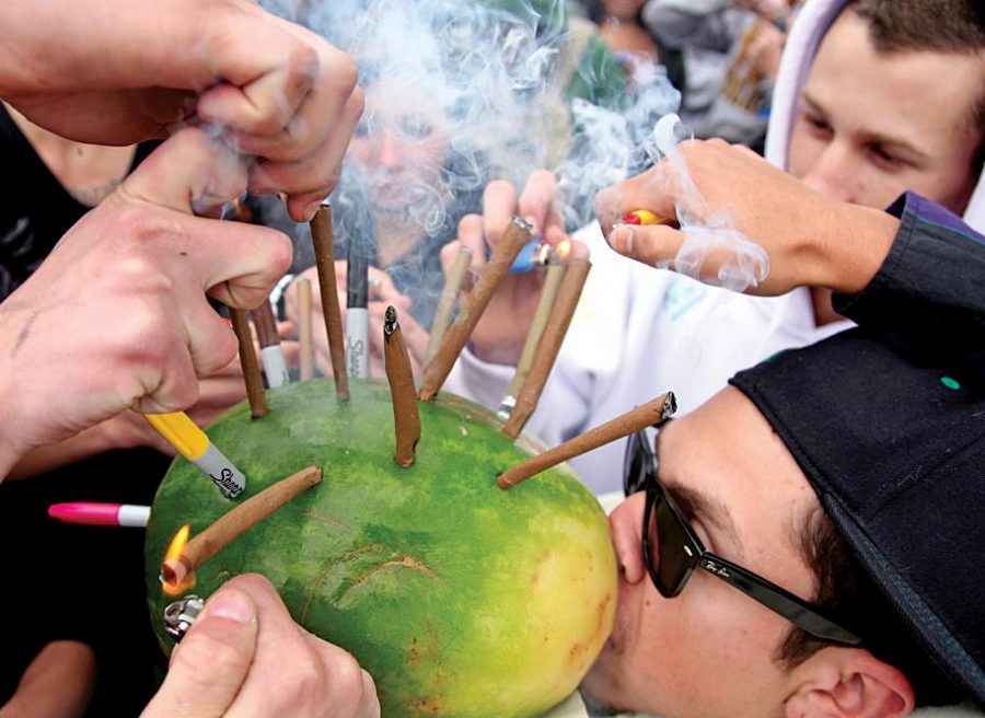 Alex Foster, from Colorado Springs, takes a toke on a hollowed-out watermelon loaded with marijuana blunts on 420 in 2011 in Boulder as friends and complete strangers provide combustion. Tomorrow Cheba Hut will host its annual 420 party where you can get a sandwich and frisbee for $4.20.