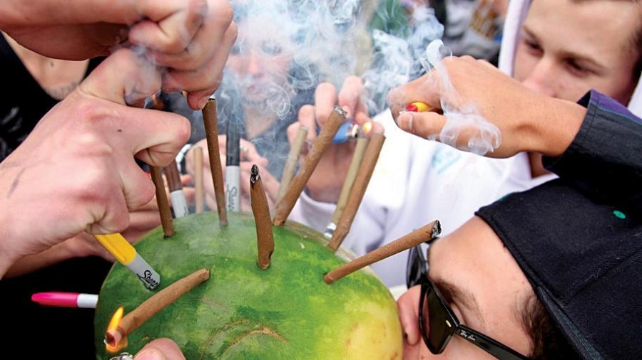 Alex Foster, from Colorado Springs, takes a toke on a hollowed-out watermelon loaded with marijuana blunts on 420 in 2011 in Boulder as friends and complete strangers provide combustion. Tomorrow Cheba Hut will host its annual 420 party where you can get a sandwich and frisbee for $4.20.