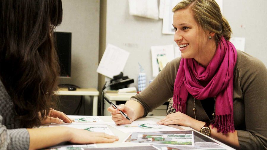 Danling Hu (left) and Emily Molzahn (right) discuss landscape concept drawings in their office in the Facilities Management building at CSU on Tuesday afternoon. Hu is a graduate landscape architect major and Molzahn is an interior design grad student.