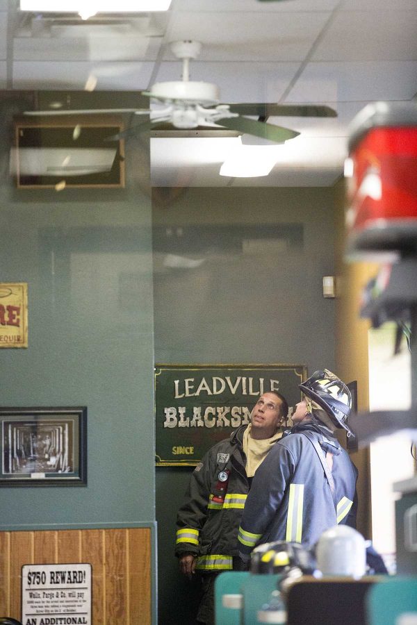 Firemen stare up at the collapsed part of the ceiling in Silver Mine Subs on Elizabeth in Fort Collins.