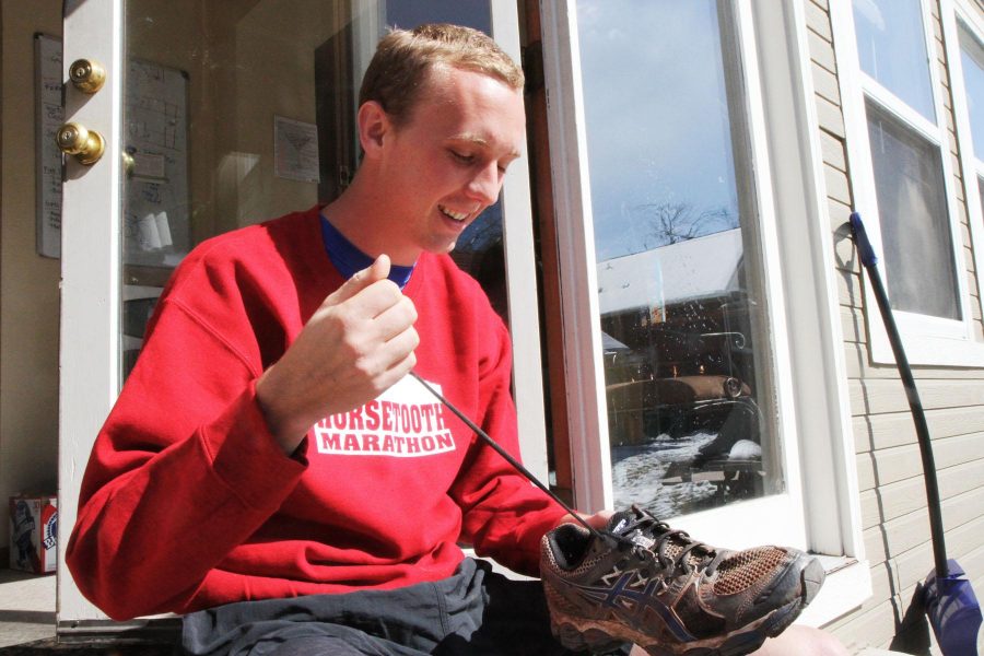 Spencer Hachmeister laces up his beaten running shoes to prepare for his first run after completeing the Horsetooth Marthon this past weekend. Like many CSU students, Hachmeister has a passion for running and is planning on completing several popular 5K and 10K races this coming summer.