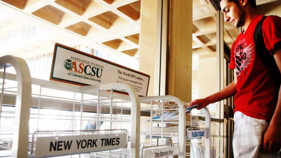 Chemical engineering student, Waleed Alkhunaizi, grabs a USA Today paper in the Clark C building Monday morning. Alkhunaizi says he usualy finds his papers here or in the LSC.