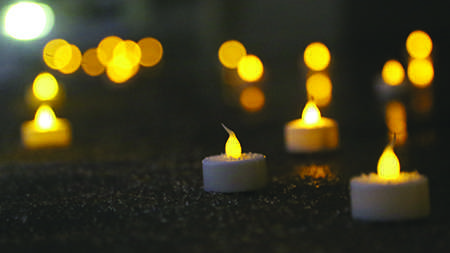 Tealights rest on the steps of the Administration building Tuesday evening at the Vigil in honor of those lost and injured in Mondays Boston Marathon bombings.