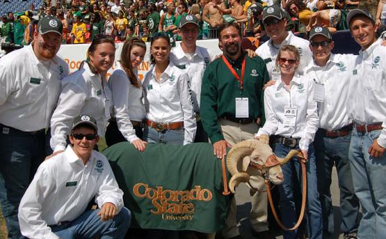 Cam the Ram is surrounded by handlers (white shirts), and Tony Frank at the Rocky Mountain Showdown in 2012 in Denver.
