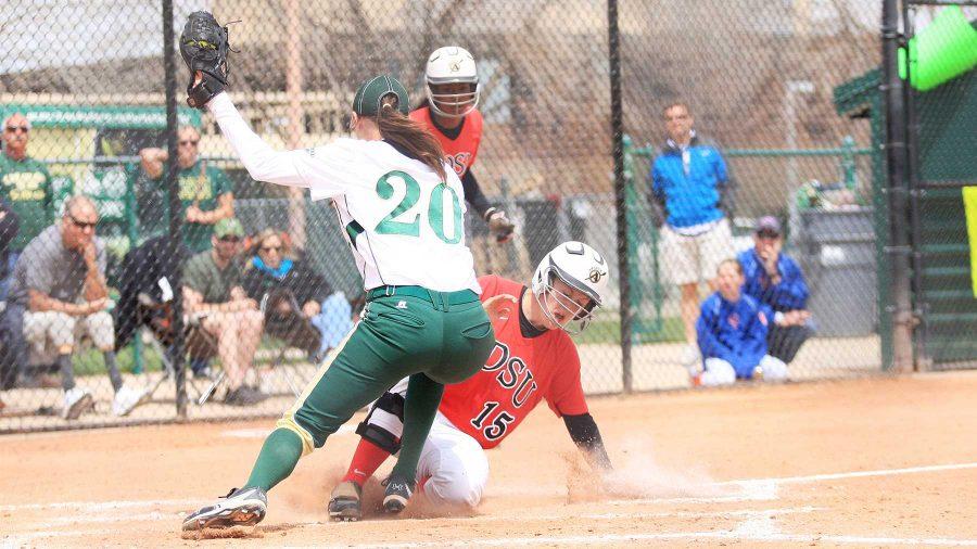 The Aztec's Katie Mathis, 15, slides into home as Ram pitcher Kacie McCarthy attempts to tag her out in Sunday's game in Fort Collins. The Rams lost 4 to 0 to the Aztecs putting their record at 24-22 for the season.