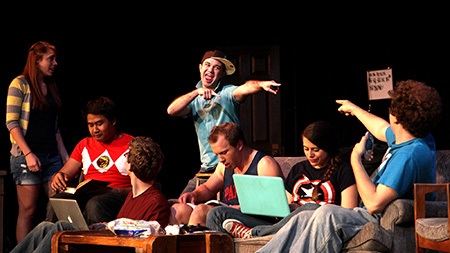Ben Hilzer, playing the lead role of Nathan, greets his friends at their apartment during a rehearsal for the YPO's College, the Musical. The performance will be showing this weekend at 7pm and at 2pm.