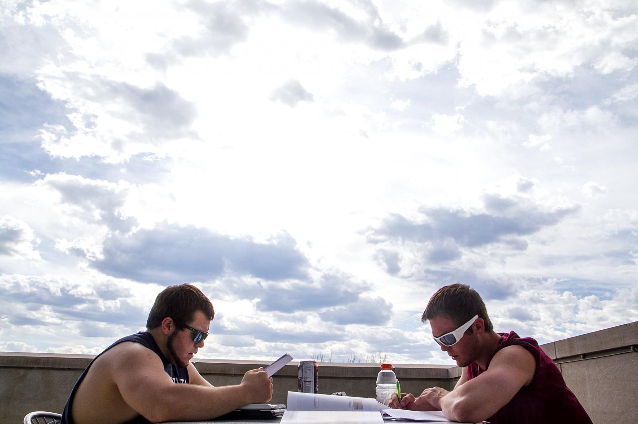 Sophomores Rusty Andres (left) and Hondo Anderson (right) study for finals atop the Behavioral Sciences Building on Sunday afternoon. With finals week ahead, students look forward to a well desserved break with Summer skies ahead.