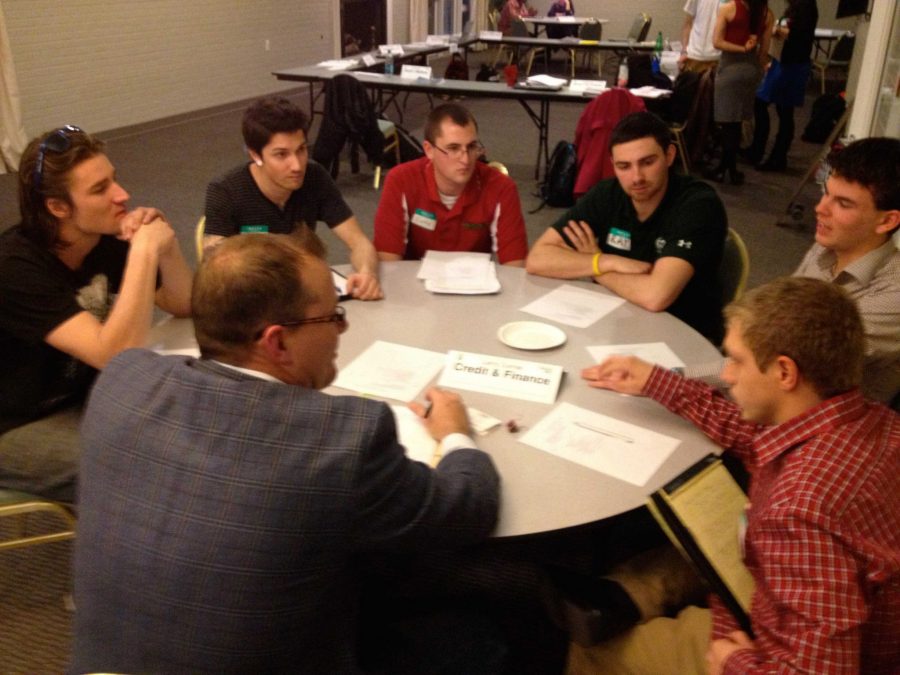 Venture Accelerator students, from left to right, Dillion Martin, Eric Beardslee, Cody Jones, Ray Chard, Menno Axt and Mitchel Friermood participate in a round table discussion with advisor Larry Curran, of Vion Investments. All of the students are trying to raise money for their small business ventures through CSU's new crowdfunding platform, Charge. 