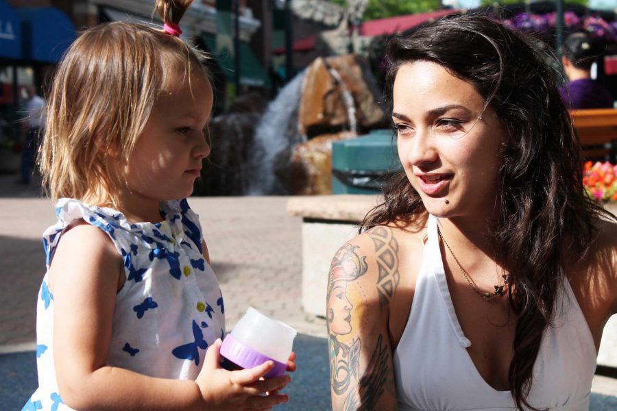 Vasquez watches as her daughter, Emma, plays in Old Town Square in Fort Collins. Vasquez hopes to open her own store front shop. 