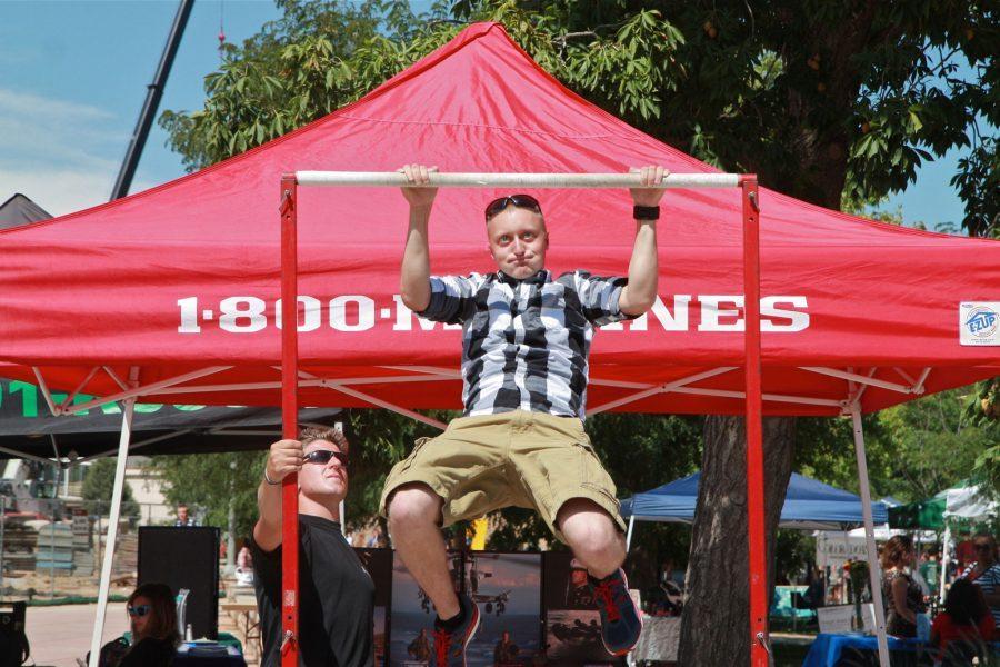 CSU Senior, Michael Hunzinger, cranks out pull-ups as Captian Emison urges him on. All day Marine recruiters challenged students to pull-ups and provided them with valuable information about the Marines.