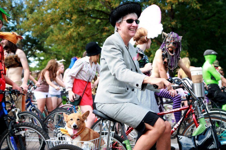 Kathleen Holland carts her dog, Jones, around Old Town on Saturday during the Tour de Fat.