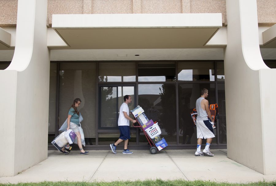 Freshman sociology major Jake Gentry, right, and Parker residents TJ Covillo and Rhonda Gentry move belongings into the Durward Residence Hall Thursday August 22, 2013. (Collegian File Photo)
