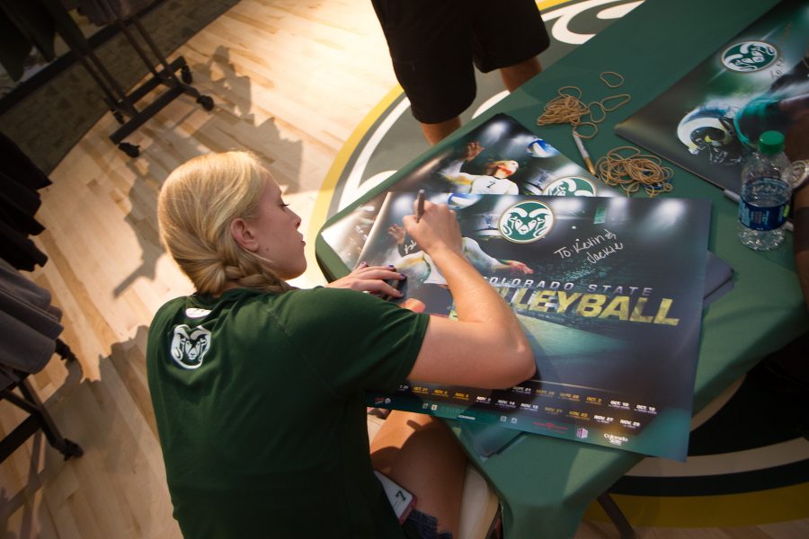 CSU Volleyball player Kelsey Snider, Soccer player Jami Vaughn, and Football player Chris Nwoke sign posters for Ram Fans at the Ram Zone in Old Town.