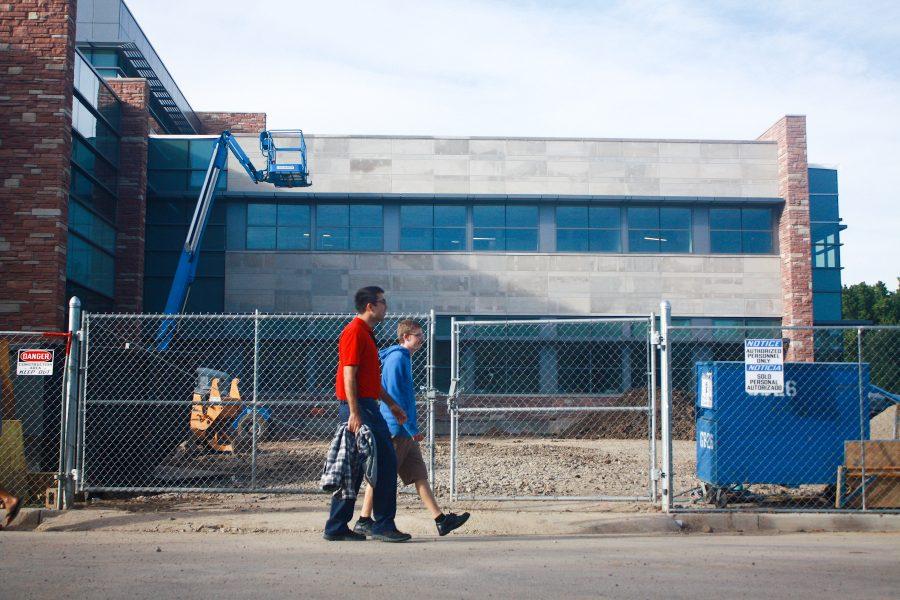 Sophmores Nick Dadlani (left) and Keegan Reynolds (right) walk past the construction of the newest addition to the Behavioral Sciences building. The addition, one of many construction projects on campus, has had to be put on hold for a while due to the weather condition.