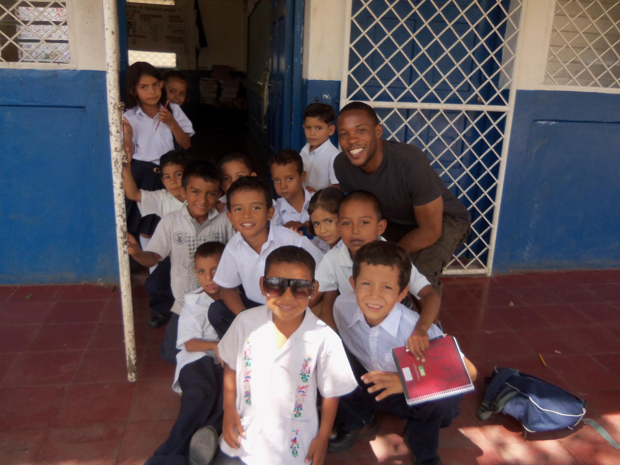 Juwon Melvin and school children stands outside of Miguel Larreynaga school in San Lorenzo, Nicaragua. Using profits from LifeSoap, Melvin and co-owner Aaron Madonna funded a clean water project at the school, contributing to well rehabilitation and latrines. Photo courtesy of Juwon Melvin.