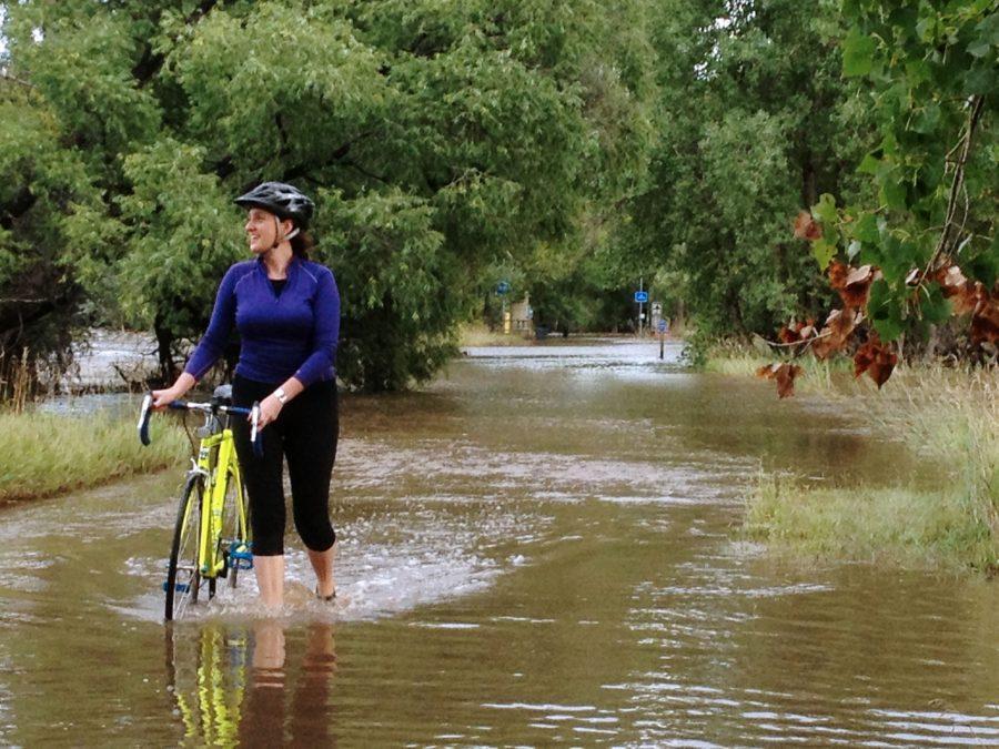Kristen Savage rides her bike along Spring Creek trail Friday afternoon.
