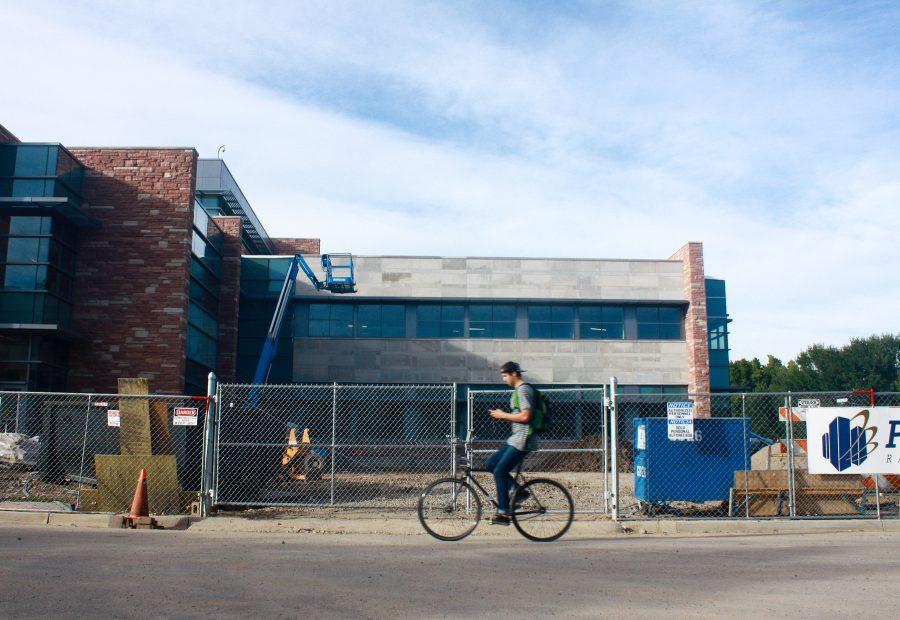A CSU Student bikes  past the construction of the newest addition to the Behavioral Sciences building. The addition, one of many construction projects on campus, has had to be put on hold for a while due to the weather condition.