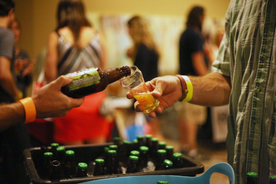 An employee of the Twisted Pine Brewery based out of Boulder pours a taster during the Fall Harvest Brewfest at the Lincoln Center on Friday night. There were over 40 breweries represented at the event to benefit Animal House, a local non-profit. 