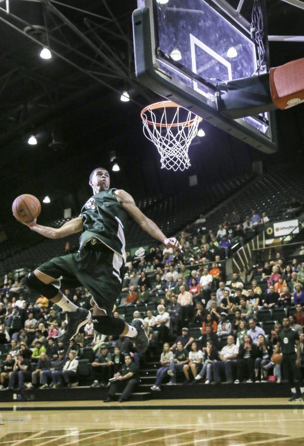 Forward Marcus Holt performs a winning dunk during Moby Madness at Moby Arena last night. The men's and woman's basketball reams showed off for the Moby crowd, offering a glipse at what's in store this season.