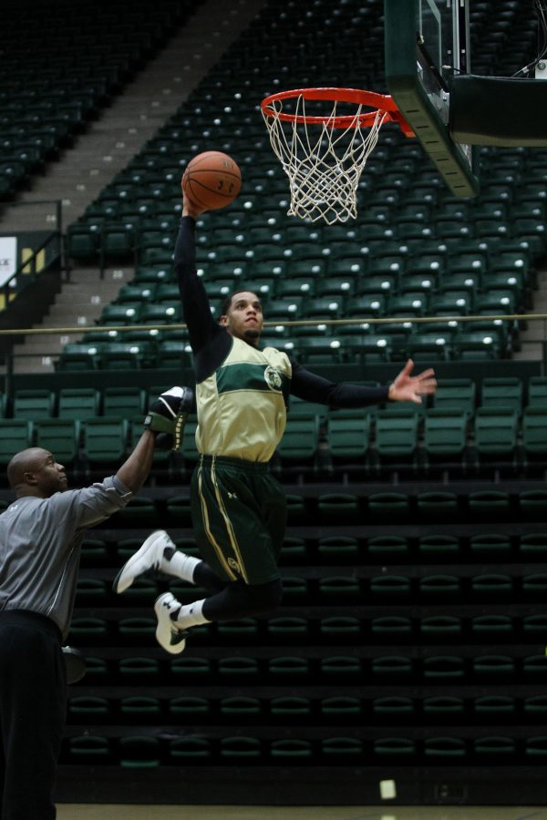 Junior guard Daniel Bejarano (2) dunks the ball at practice on Tuesday. The Rams are preparing for their upcoming game against Regis November second at 2pm in Moby.