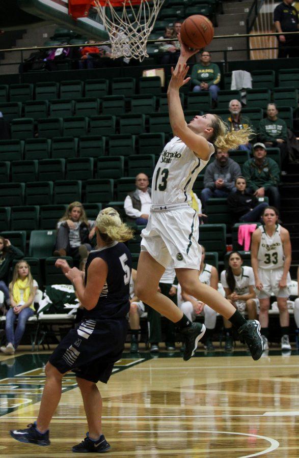 Freshman Guard Ellen Nystrom (13) goes for a layup against the Mines defence. The Rams win over Mines 95-47 during a Women's Basketball exhibition held at Moby Monday night.