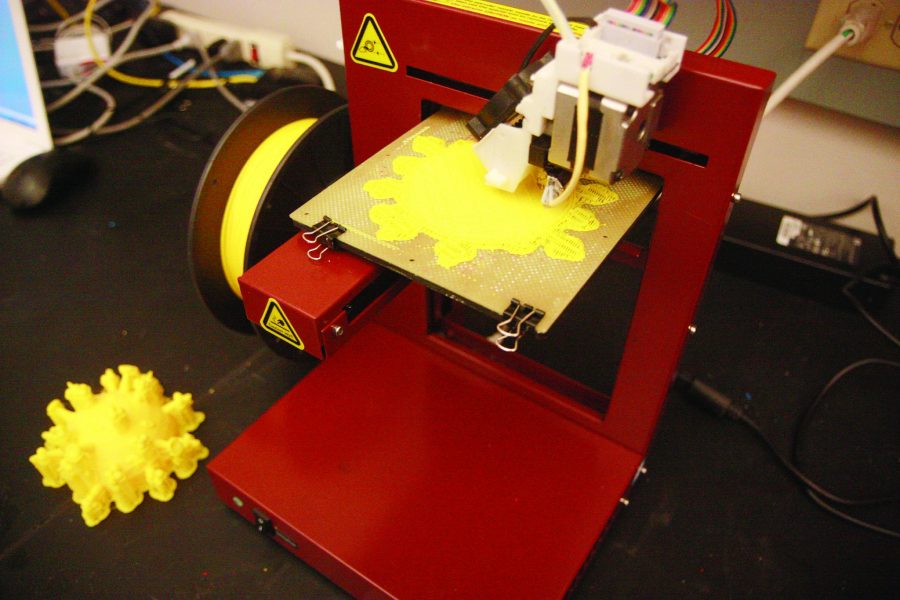 Two years in the making, David Prawell's 3D printing lab finally opened allowing engineering students to print out their projects and do research from a new dimension. Here, a student is preinting out a 3D image of the influenzia virus.