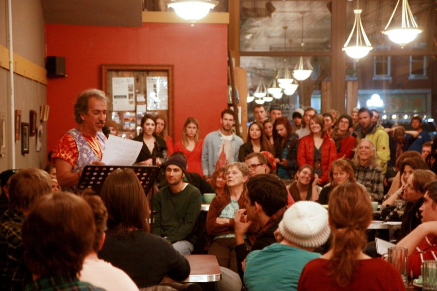 People pack into The Bean Cycle Friday night to listen to poets deliver their best lines (pictured Booger BLANK: poet and 5th-year running host of the event). Every first Friday of the month, The Bean Cycle hosts a poetry slam, where everyone is welcome to compete, dink coffee, and listen. The grand prize: a jar filled with dollar donations from the crowd.
