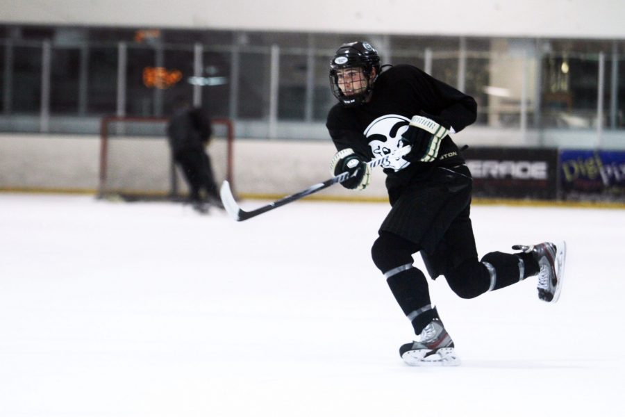 CSU hockey player speeds across the rink during sprint drills at a late night practice.