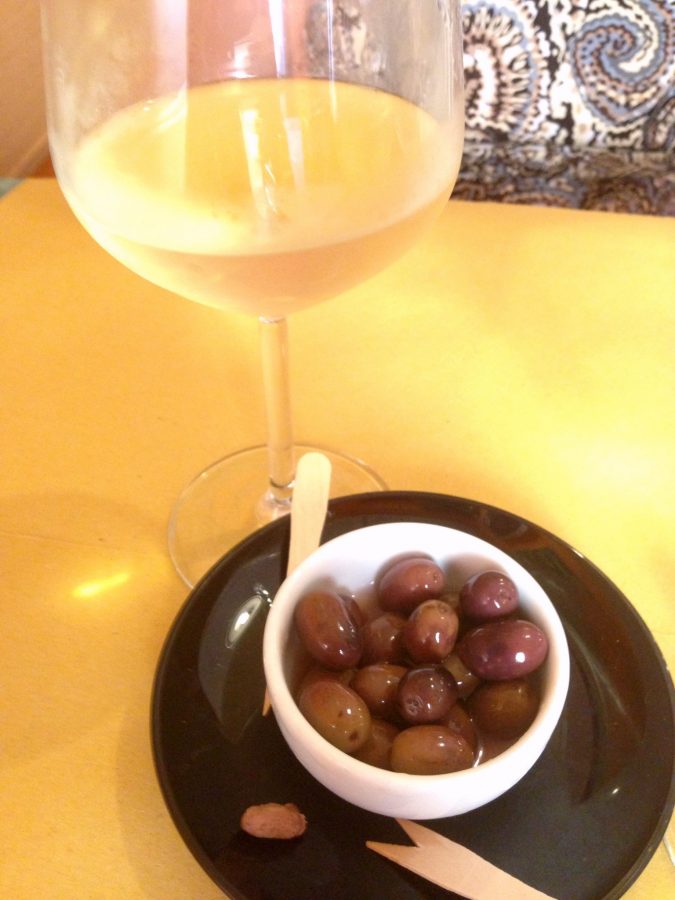 Cinque Terre white wine served with olives soaked in olive oil at Cafe Mateo