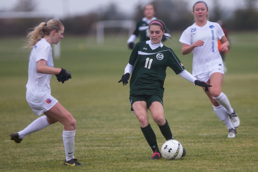 Amy Eckert of CSU attempts a pass Sunday at the Fort Collins Soccer Complex. The Rams lost to the Broncos 3-0 in wet and soggy conditions