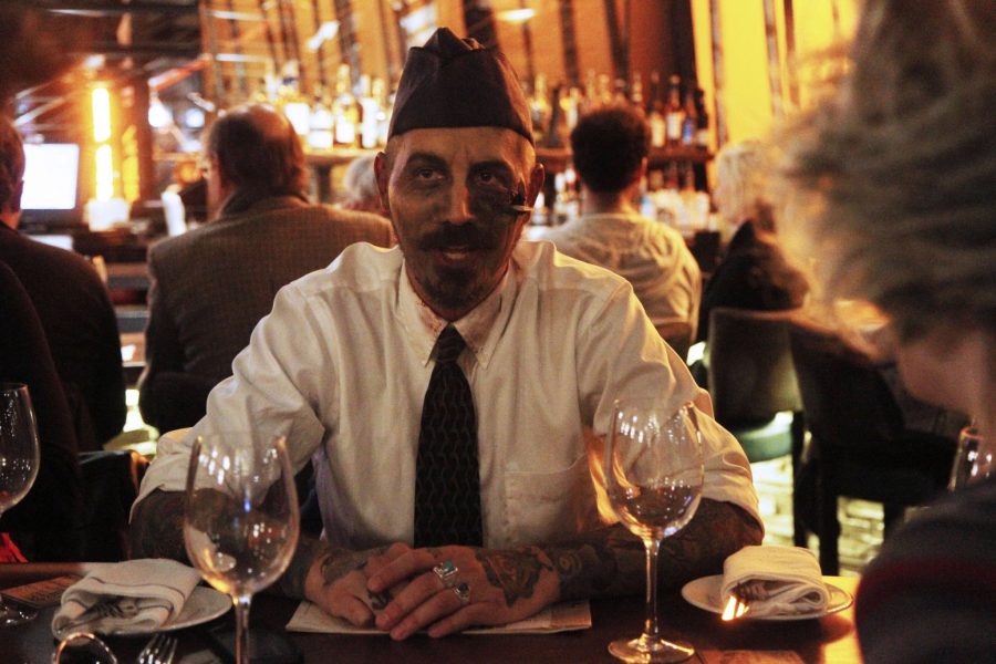 Darren Manuron dines at Mainline with undead friends, a piece of fake shrapnel precariously sticking out from his left cheek. Bars and restaurants through out are bombarded by zombie hoards looking for good food and Halloween-inspired drinks.